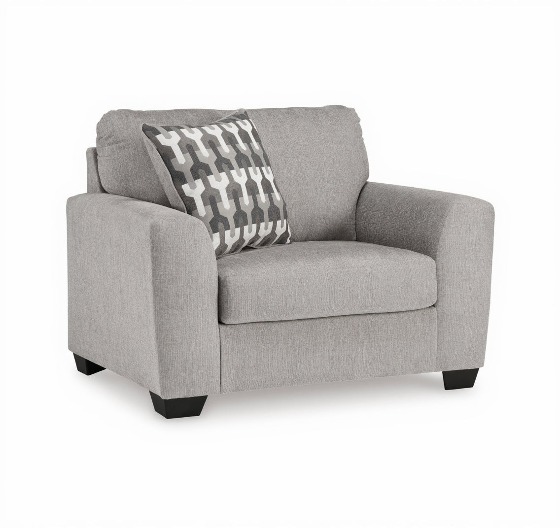 Gray armchair with a patterned pillow on a white background