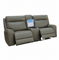 A gray leather reclining double theater sofa with a center console tray holding a portable media player, shown on a plain white background.