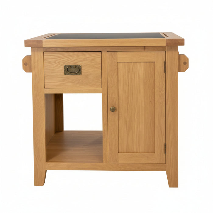 A small wooden kitchen bench cabinet or side table made of natural oak wood, featuring a single drawer with a brass pull, a lower open shelf, and a dark rectangular top surface.